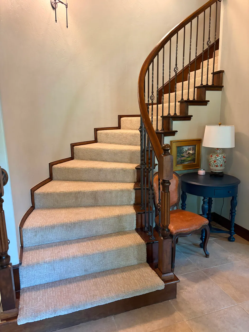 Curved staircase wrapped in soft neutral carpet installed in an OKC home