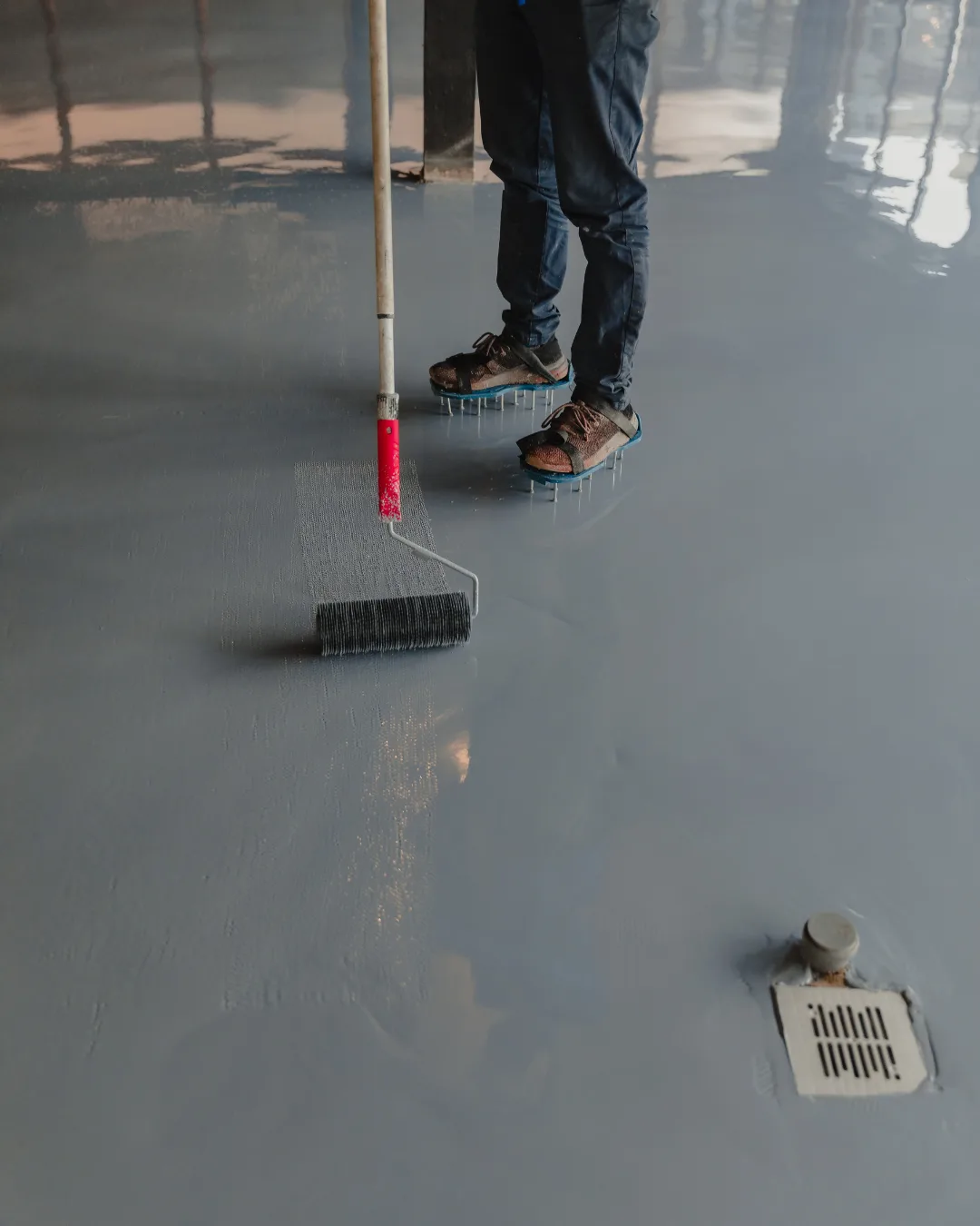 Epoxy concrete coating being installed on a commercial floor