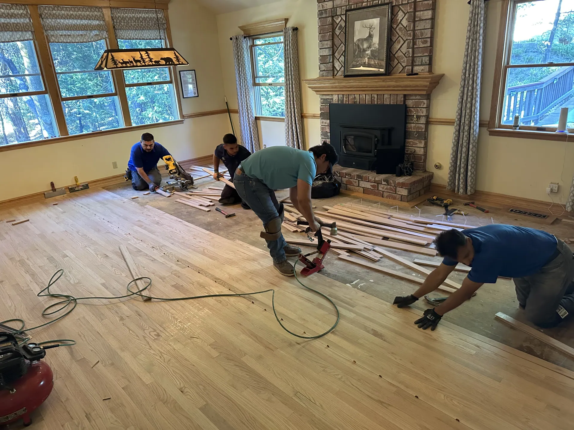 Floors To You OKC installation team measuring and laying new floors in an Oklahoma City home